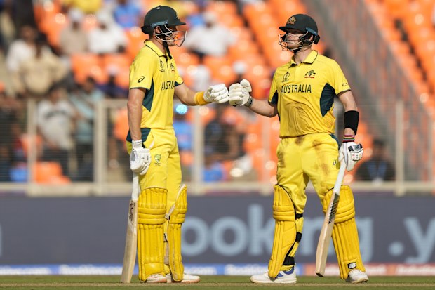 Australia's Steve Smith, right, and teammate Marnus Labuschagne touch gloves during the ICC Men's Cricket World Cup match between Australia and England in Ahmedabad, India, Saturday, Nov. 4, 2023. (AP Photo/Mahesh Kumar A.)