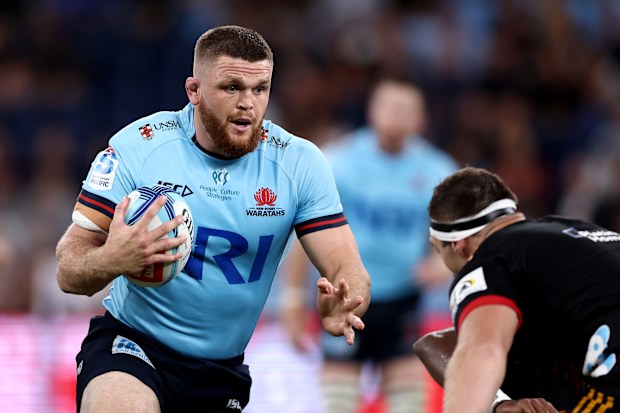 Lachlan Swinton of the Waratahs runs with the ball.
