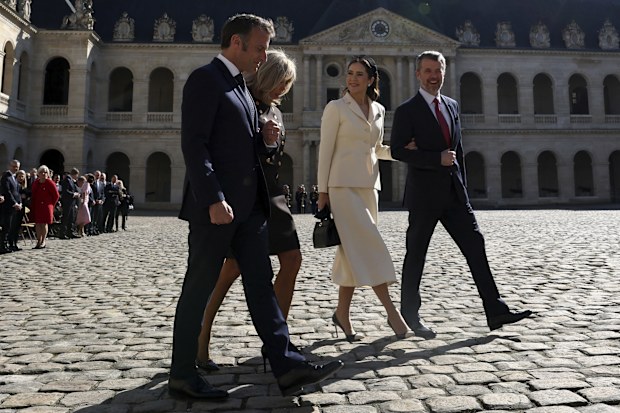 French President Emmanuel Macron and his wife Brigitte Macron, left, walk with Denmark's Queen Mary and Denmark's King Frederik X during an official welcome ceremony in the courtyard of the Invalides monument, in Paris, Monday, March 31, 2025.(Gonzalo Fuentes/Pool via AP)