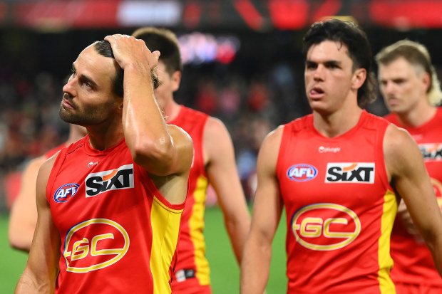 MELBOURNE, AUSTRALIA - MARCH 26: The Suns look dejected after losing the round two AFL match between Essendon Bombers and Gold Coast Suns at Marvel Stadium, on March 26, 2023, in Melbourne, Australia. (Photo by Quinn Rooney/Getty Images)