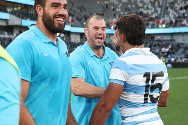 Michael Cheika celebrates with Santiago Carreras of the Pumas after beating the All Blacks.