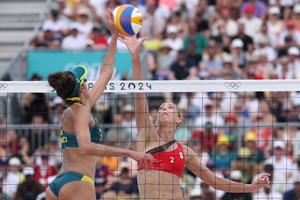 Taliqua Clancy attacks the net against Sophie Bukovec of Canada. 