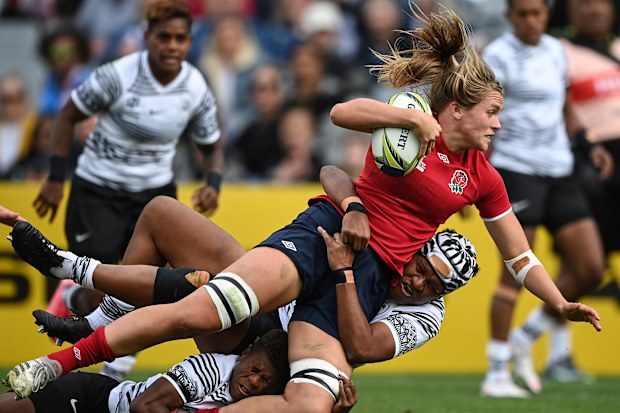 Zoe Aldcroft of England is tackled by a defender.