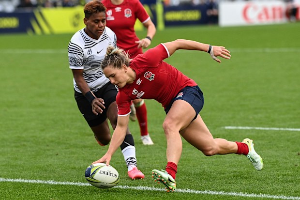 Claudia MacDonald of England scores a try.