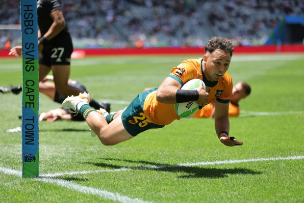 Australia's Hayden Sargeant dives in a try against New Zealand on day one of the SVNS at Cape Town Stadium.