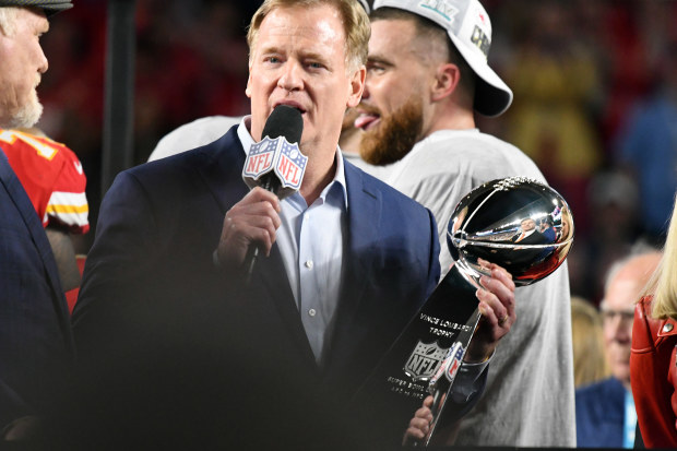 NFL Commissioner Roger Goodell presents the Lombardi Trophy.