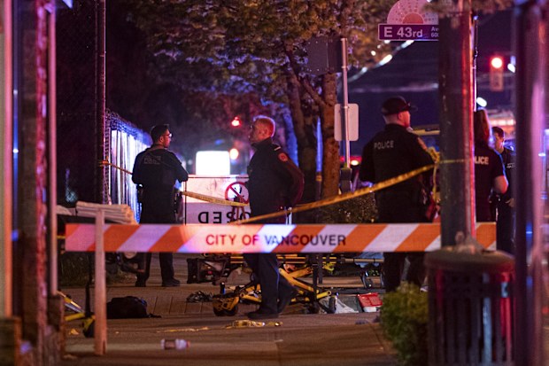Vancouver police examine a black car suspected to be involved at a scene after a vehicle drove into a crowd at the Lapu Lapu Festival in Vancouver, British Columbia, Canada.