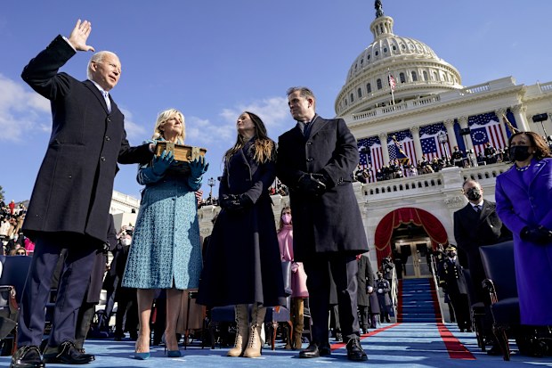 Joe Biden is sworn in as the 46th President of the United States at the Capitol in Washington on Wednesday, Jan. 20, 2021, as his wife Jill Biden holds a bible and his daughter Ashley Biden and son Hunter Biden look on. (Andrew Harnik/Pool via The New York Times) -- FOR EDITORIAL USE ONLY --