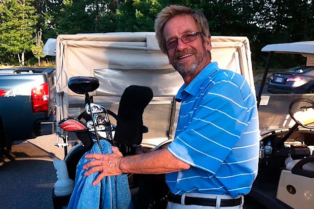 Tom Randele, whose real name according to authorities is Ted Conrad, tends to golf clubs, in September of 2012. 
