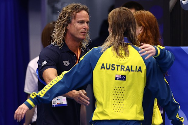 FUKUOKA, JAPAN - JULY 26:  Australian swim coach Dean Boxall hugs silver medallist Ariarne Titmus of Team Australia and gold medallist Mollie O'Callaghan of Team Australia and silver medallist Ariarne Titmus of Team Australia during the medal ceremony for Women's 200m Freestyle Final on day four of the Fukuoka 2023 World Aquatics Championships at Marine Messe Fukuoka Hall A on July 26, 2023 in Fukuoka, Japan. (Photo by Clive Rose/Getty Images)