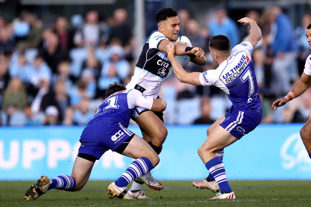SYDNEY, AUSTRALIA - AUGUST 27: Kayal Iro of the Sharks is tackled by the Bulldogs defence during the round 24 NRL match between the Cronulla Sharks and the Canterbury Bulldogs at PointsBet Stadium, on August 27, 2022, in Sydney, Australia. (Photo by Brendon Thorne/Getty Images)