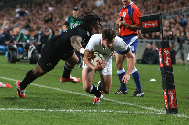 Freddie Burns of England is knocked into touch by Ma'a Nonu at Eden Park.