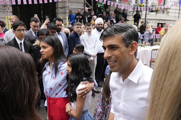 Prime Minister Rishi Sunak and his family, left, attend the Big Lunch party at Downing Street in London Sunday, May 7, 2023. 