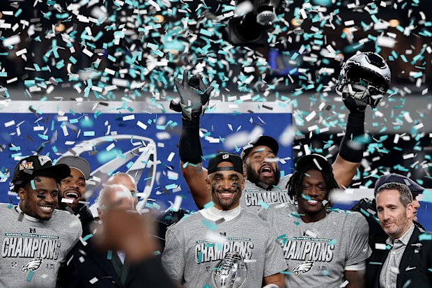Jalen Hurts #1 of the Philadelphia Eagles and teammates celebrate during the trophy ceremony after their 55-23 win against the Washington Commanders during the NFC Championship Game at Lincoln Financial Field on January 26, 2025 in Philadelphia, Pennsylvania.  (Photo by Emilee Chinn/Getty Images)
