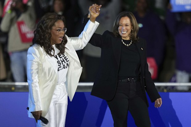Oprah Winfrey holds hands with Democratic presidential nominee Vice President Kamala Harris after introducing Harris to speak during a campaign rally outside the Philadelphia Museum of Art, Monday, Nov. 4, 2024, in Philadelphia. (AP Photo/Matt Slocum)