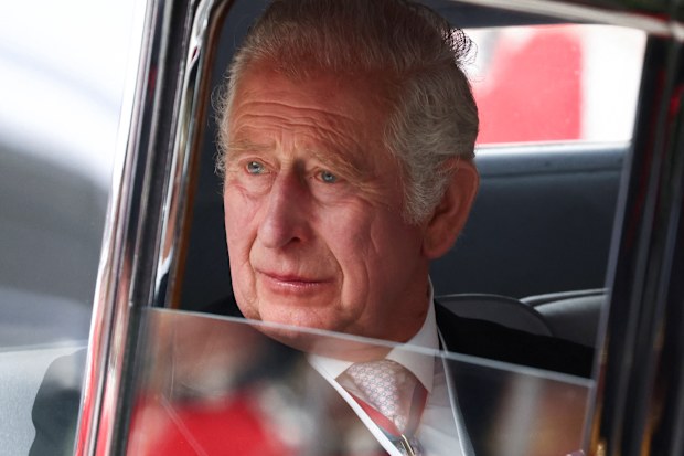 King Charles pictured in 2022, looking out of a car window.