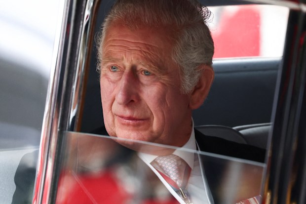 King Charles pictured in 2022, looking out of a car window.