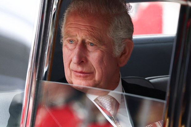 King Charles pictured in 2022, looking out of a car window.