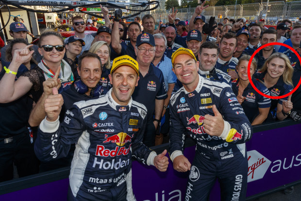Jamie Whincup and Craig Lowndes celebrate victory at the Gold Coast 600 with Triple Eight Race Engineering team members including Jessica Dane (circled).