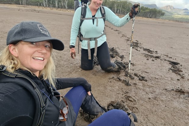 Lauren Thomas and Steph Brake trekking through mud to prepare for their 40 day hike.