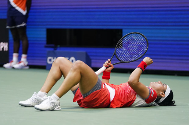 Ons Jabeur, of Tunisia, lies on the court after chasing down a shot from Iga Swiatek, of Poland, during the women's singles final of the U.S. Open tennis championships, Saturday, Sept. 10, 2022, in New York. (AP Photo/Frank Franklin II)