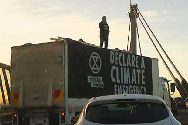 Extinction Rebellion protestors atop rented truck on West Gate Bridge (Nine)
