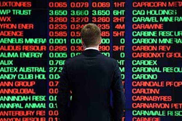 Man standing in front of ASX boards (AAP)