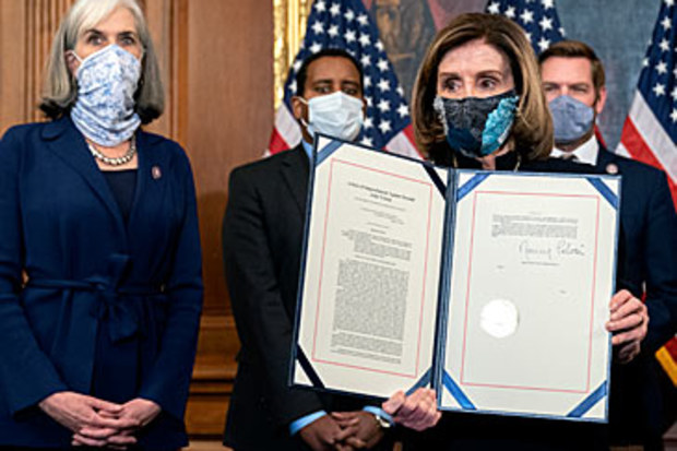 Nancy Pelosi with impeachment documents (Getty)