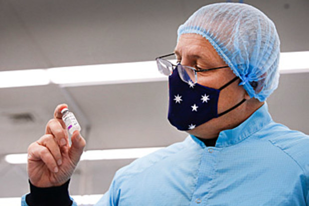 Scott Morrison with AstraZeneca COVID-19 vaccine vial (Getty)