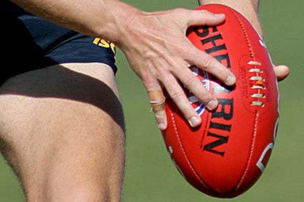 AFL player with football (AAP)