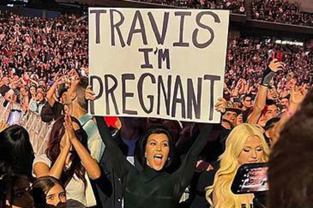 Kourtney Kardashian with 'Travis I'm Pregnant' poster (Instagram)