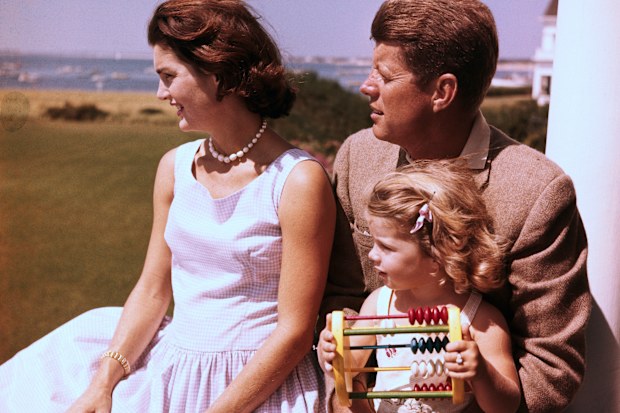 Senator John F. Kennedy relaxes w/ his wife Jacqueline and daughter Caroline.