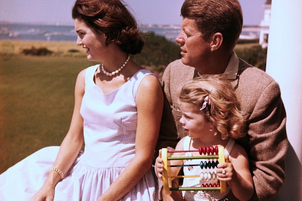 Senator John F. Kennedy relaxes w/ his wife Jacqueline and daughter Caroline.