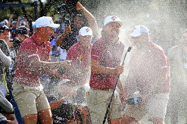 DALLAS, TEXAS - SEPTEMBER 22: Cameron Smith of Australia and The Ripper GC team is soaked with champagne by his teammates Lucas Herbert, Marc Leishman and Matt Jones after holing teh winning putt on the 18th green  during the individual team stroke-play finals on day three of the LIV Golf Team Championship Dallas at Maridoe Golf Club on September 22, 2024 in Dallas, Texas. (Photo by David Cannon/Getty Images)