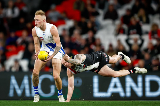 MELBOURNE, AUSTRALIA - JULY 23: Jaidyn Stephenson of the Kangaroos is tackled by Zak Jones of the Saints during the 2023 AFL Round 19 match between the St Kilda Saints and the North Melbourne Kangaroos at Marvel Stadium on July 23, 2023 in Melbourne, Australia. (Photo by Dylan Burns/AFL Photos via Getty Images)