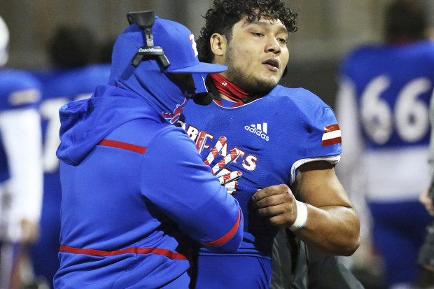 Edinburg High's Emmanuel Duron is pulled from the field by coaching staff after charging a referee.
