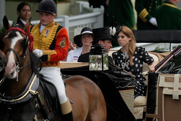Britain's Princess Beatrice, at right, reacts as a horse leading her carriage becomes unsettled on the fifth day of the Royal Ascot horserace meeting, at Ascot Racecourse, in Ascot, England, Saturday, June 18, 2022. (AP Photo/Alastair Grant)