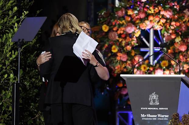 Shane Warne's children Brooke, Jackson and Summer embrace after speaking at the cricketer's memorial