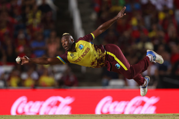 Andre Russell of the West Indies fields off his own delivery.