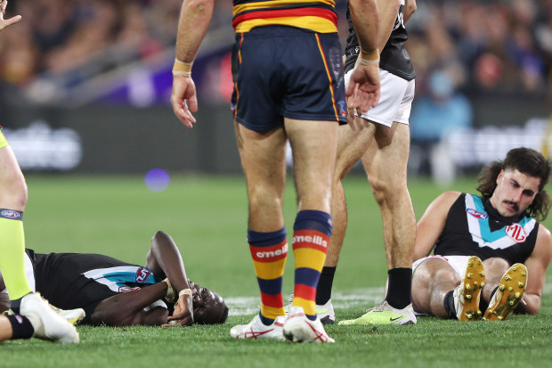ADELAIDE, AUSTRALIA - JULY 29: Aliir Aliir of the Power on the ground along with Lachie Jones of the Power after they collided during the 2023 AFL Round 20 match between the Adelaide Crows and the Port Adelaide Power at Adelaide Oval on July 29, 2023 in Adelaide, Australia. (Photo by Sarah Reed/AFL Photos via Getty Images)