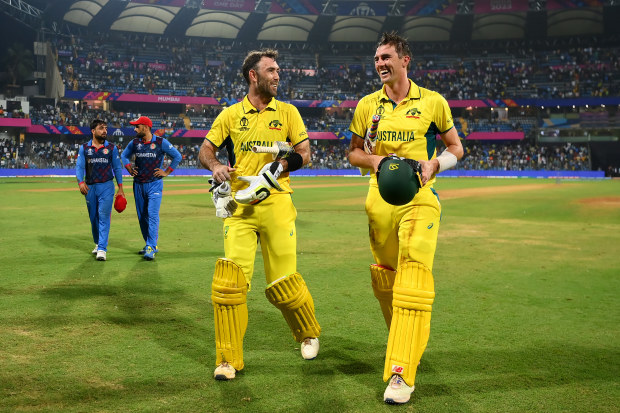 MUMBAI, INDIA - NOVEMBER 07: Glenn Maxwell of Australia celebrates with team mate Pat Cummins after hitting a six for the winning runs, finishing unbeaten on 201 not out  during the ICC Men's Cricket World Cup India 2023 match between Australia and Afghanistan at Wankhede Stadium on November 07, 2023 in Mumbai, India. (Photo by Alex Davidson-ICC/ICC via Getty Images)