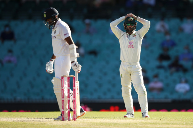 Ravichandran Ashwin of India walks away as Matthew Wade of Australia shows his frustration.
