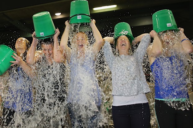Participants sign up to take part in the World Record Ice Bucket Challenge at Etihad Stadium on August 22, 2014 in Melbourne, Australia.  The Ice Bucket Challenge is the social media phenomenon which is helping raise awareness and money for sufferers of Motor Neurone Disease.