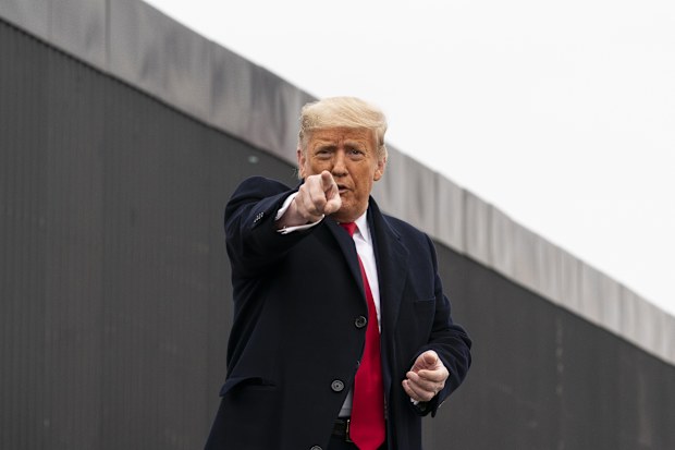 US President Donald Trump points to a member of the audience.