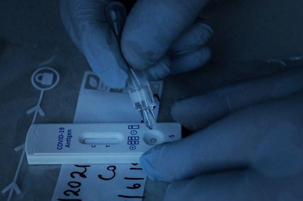 Dr Jeremy Cumpston conducts a COVID-19 rapid antigen test of construction workers at Mirvac Constructions Green Square site 15 in Zetland before they can start work. Zetland, NSW. 11th August, 2021. Photo: Kate Geraghty