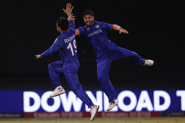 Rashid Khan of Afghanistan celebrates with teammate Fazalhaq Farooqi after dismissing Michael Bracewell.