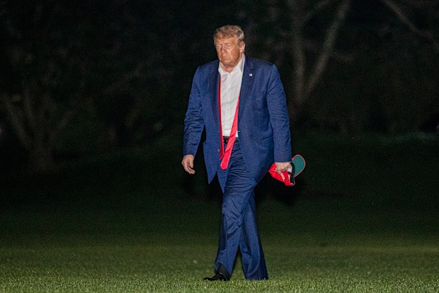 President Donald Trump walks on the South Lawn of the White House in Washington, Sunday, June 21, 2020, after stepping off Marine One as he returns from a campaign rally in Tulsa, Okla. (AP Photo/Patrick Semansky)
