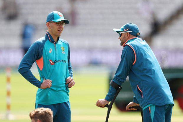 LONDON, ENGLAND - JUNE 30: Nathan Lyon of Australia speaks with teammate Todd Murphy while on crutches after sustaining an injury on Day Two during warm up prior to Day Three of the LV= Insurance Ashes 2nd Test match between England and Australia at Lord's Cricket Ground on June 30, 2023 in London, England. (Photo by Ryan Pierse/Getty Images)