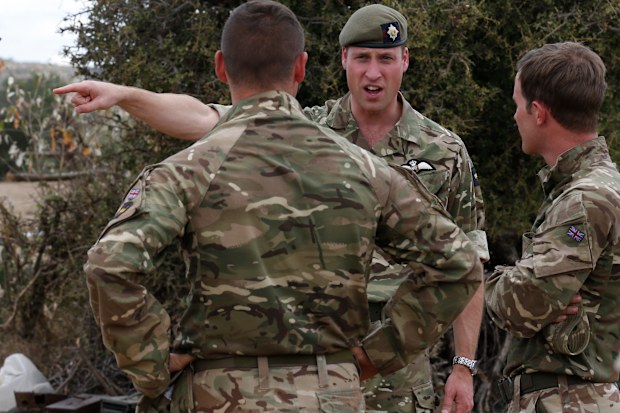 Britain's Prince William, 2nd right, speaks to soldiers during a visit to the 1st Battalion the Irish Guards battle group, training under the British Army Training Unit Kenya (BATUK), in his role as Colonel of the Regiment, in Laikipia, Kenya Sunday, Sept. 30, 2018. Britain's Prince William, who has campaigned against the killing of elephants, rhinos, and other species, is in Africa this week to discuss threats to conservation ahead of a London conference on the illegal wildlife trade. 