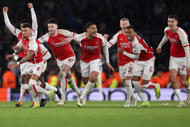 Players of Arsenal celebrate as David Raya of Arsenal (not pictured) makes the match-winning save from the fourth penalty from Galeno of FC Porto in the penalty shoot out during the UEFA Champions League.